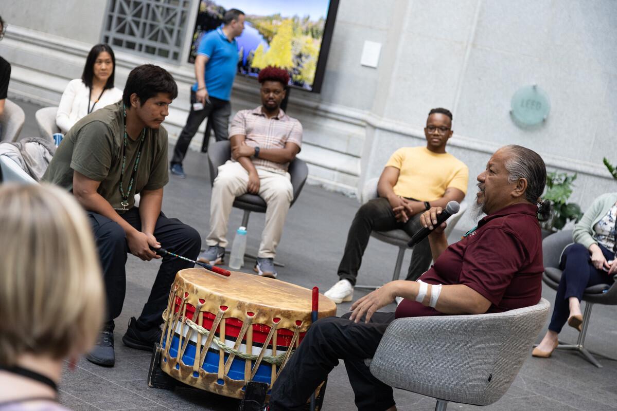 Audience members watching the Ottawa River Singers discuss drumming